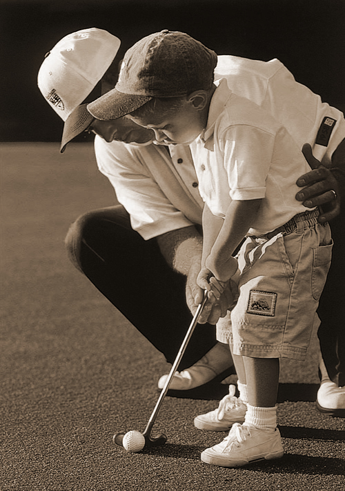 father helping his son how to put