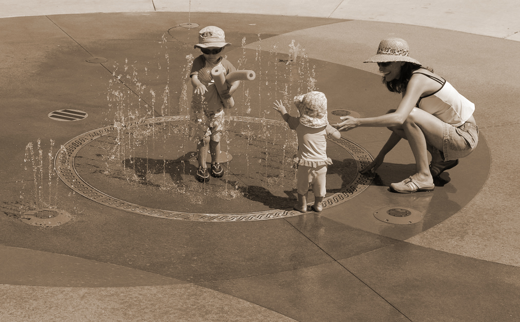 kids playing in sprinkler